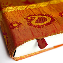 Load image into Gallery viewer, Close-up of an orange fabric with embroidered patterns on a white background