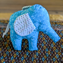 Load image into Gallery viewer, Blue elephant plush on a patterned fabric background