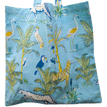 Load image into Gallery viewer, Tote bag with tropical animal and plant pattern on a blue background