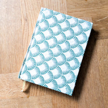 Load image into Gallery viewer, Green and white patterned book on a wooden surface