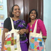 Load image into Gallery viewer, smiling artisans modelling square design sari patchwork cotton tote bags against brown door and blue wall