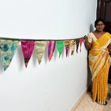 Load image into Gallery viewer, Upcycled sari flags, reusable sari bunting held up by artisan