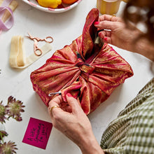 Load image into Gallery viewer, gift wrapped in red and gold sari gift wrap on a white surface