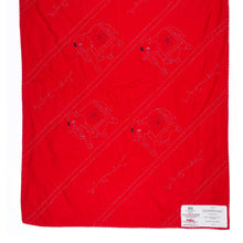 Load image into Gallery viewer, Red blanket with black patterns on a white background
