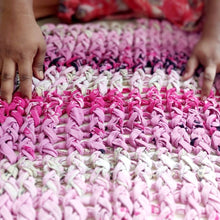Load image into Gallery viewer, artisan working on pink chunky knit cushion cover
