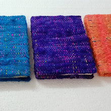 Load image into Gallery viewer, Colorful textured books arranged in a row on a white surface
