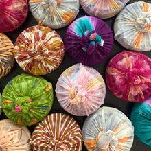 Load image into Gallery viewer, Colorful fabric gift wrapped items arranged on a dark surface
