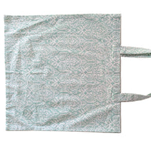 Load image into Gallery viewer, Patterned tote bag on a beige background
