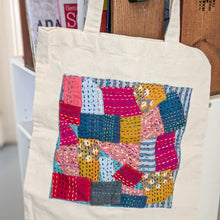 Load image into Gallery viewer, Square design sari patchwork cotton tote bag hanging from wooden crate filled with books
