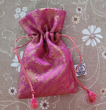 Load image into Gallery viewer, Pink sari gift bag with drawstring on beige floral surface
